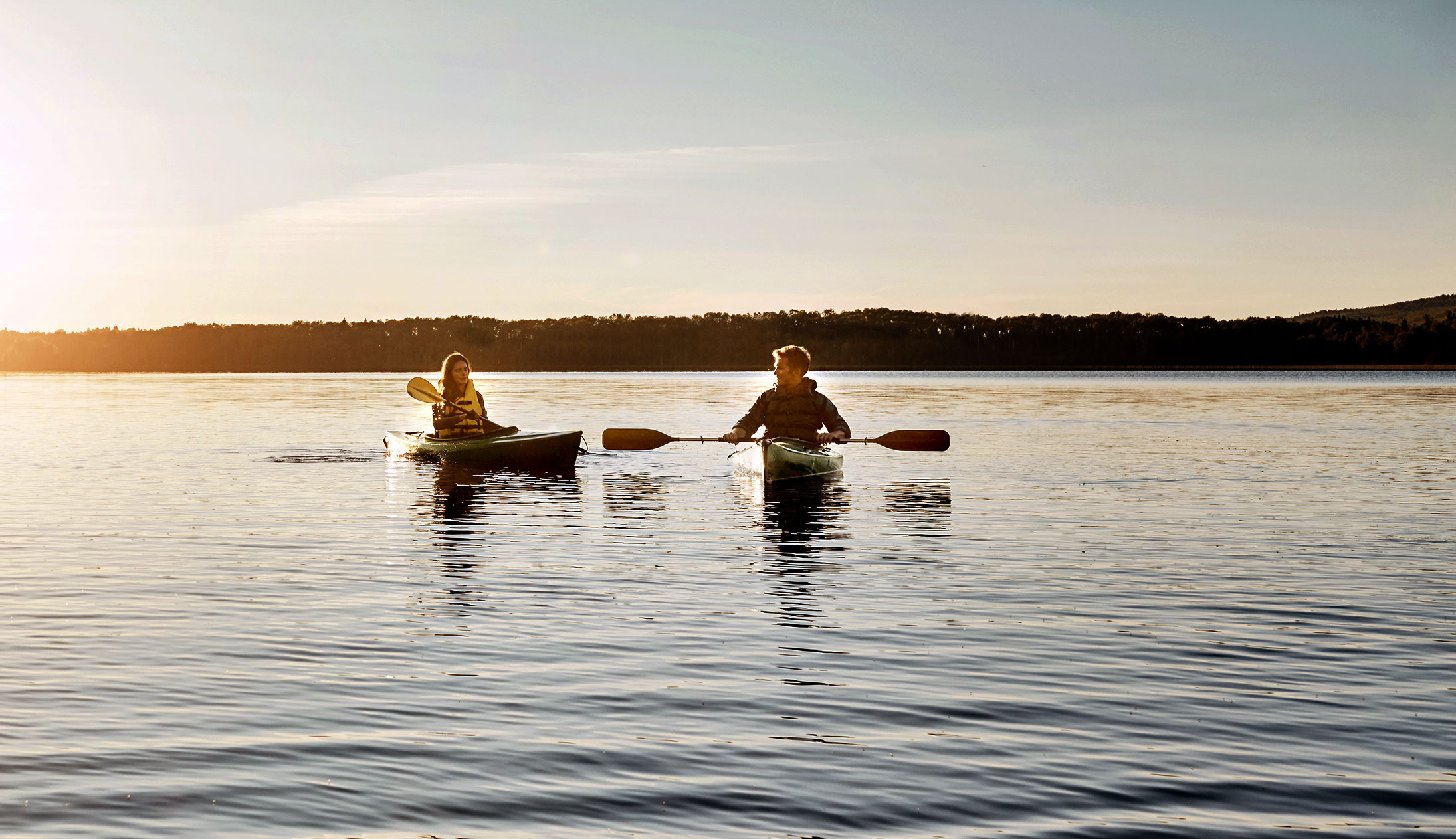 Kayakers at Sunrise on large lake