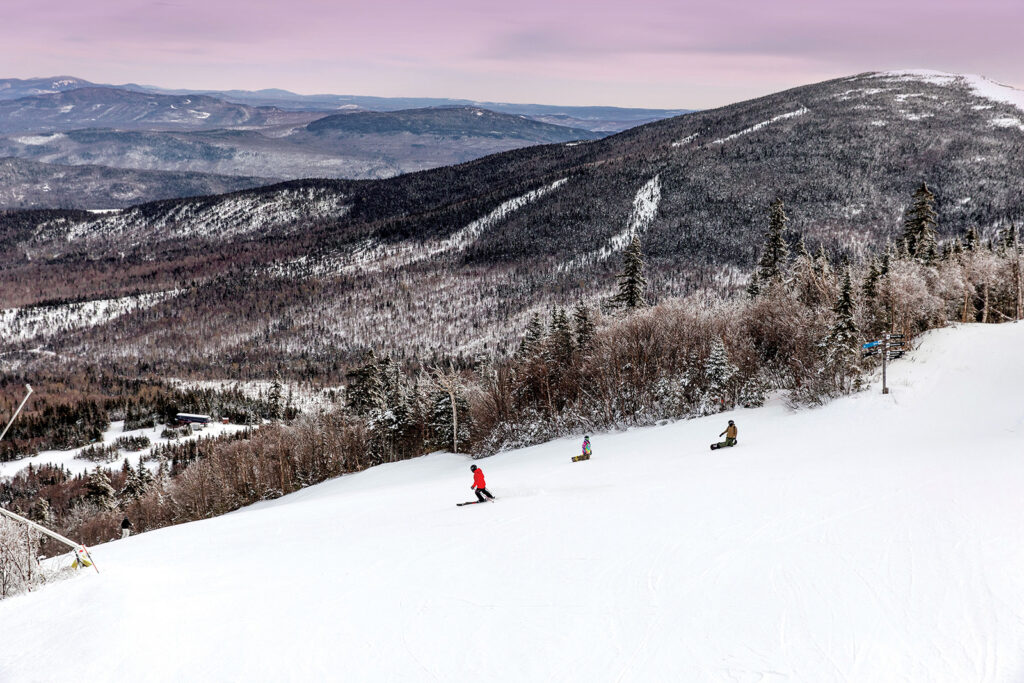 Snowboarding on the slopes in Maine's Lakes and Mountains